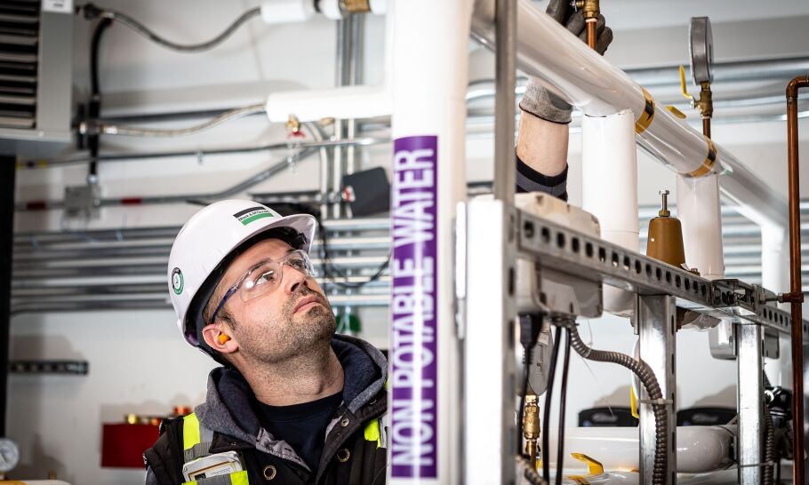 Black & McDonald Worker checking the pump