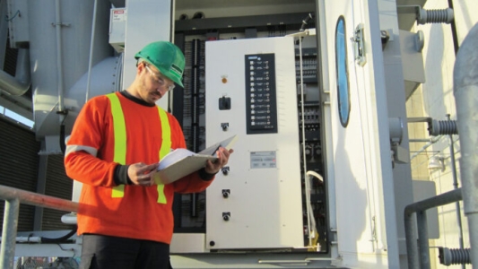 B&M service technician providing scheduled maintenance services for an electrical system at a property