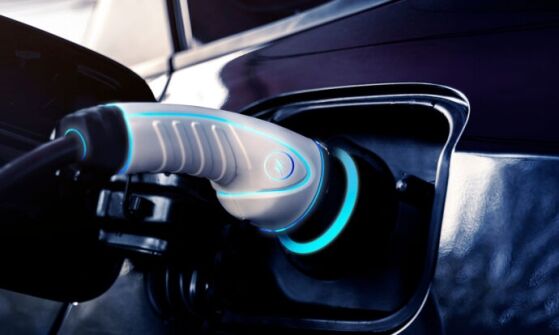 A pair of EV chargers are connected to two electric vehicles.